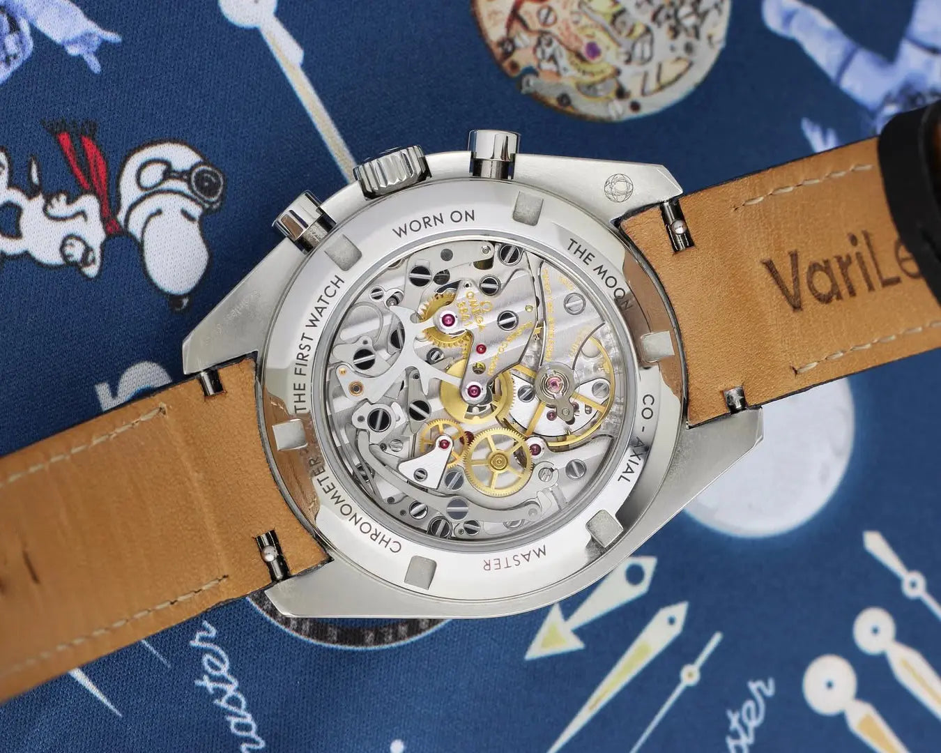 Quick-release spring bar on a curved-end leather strap fitted to a luxury Omega Speedmaster watch